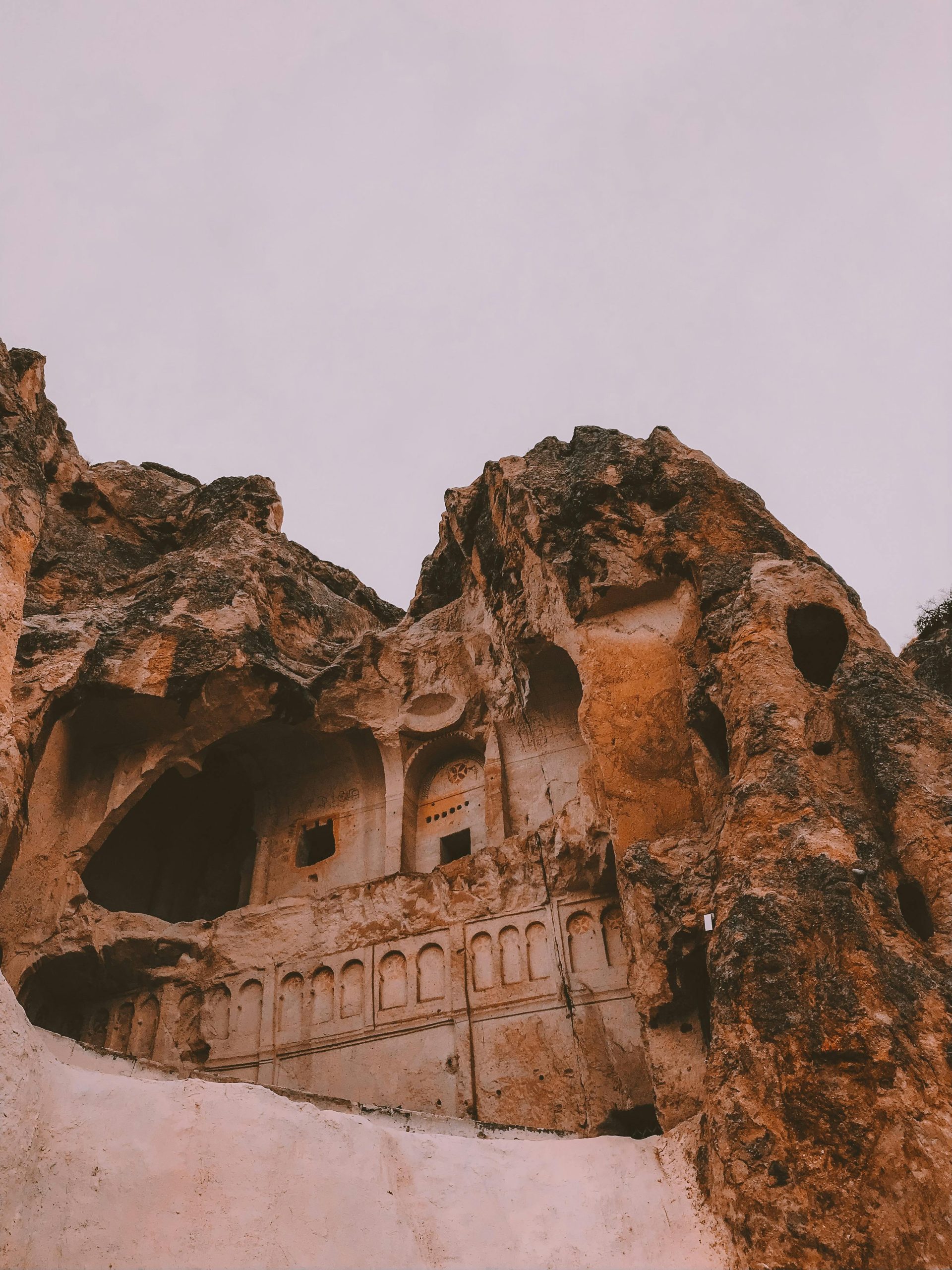 Explore the ancient carved rock formations of Cappadocia with historic stone architecture.