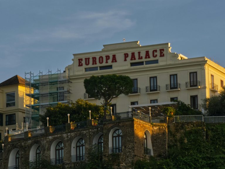 Europa Palace Hotel facade illuminated by warm sunset light capture.